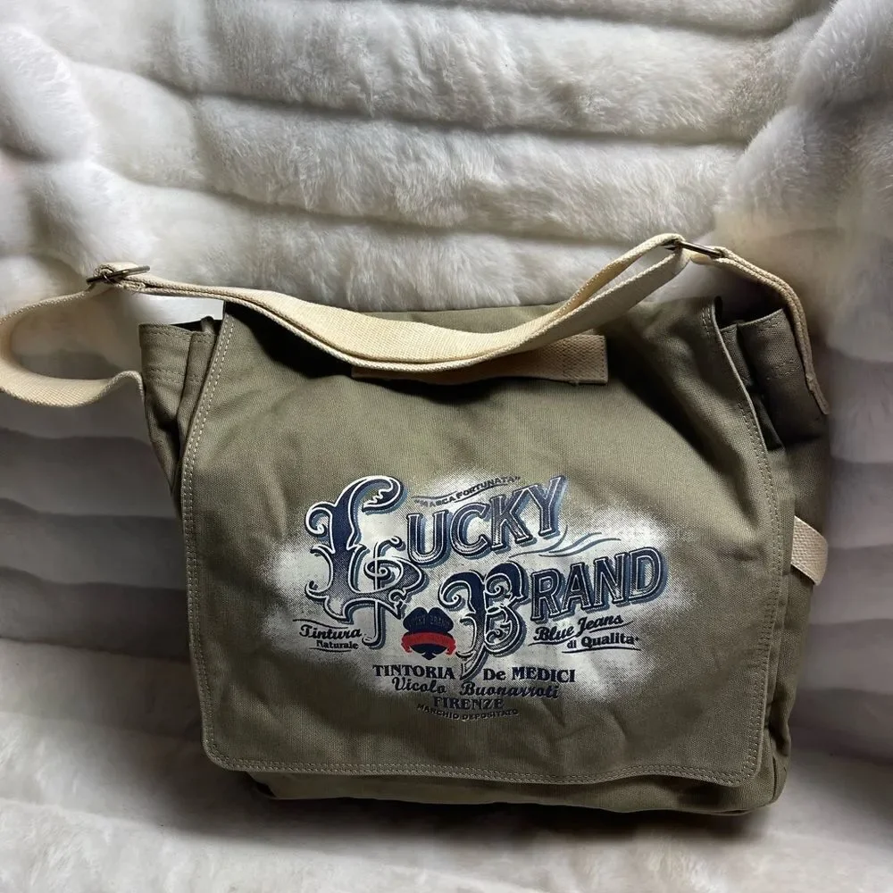 Lucky Brand large canvas olive green messenger bag with adjustable beige strap.